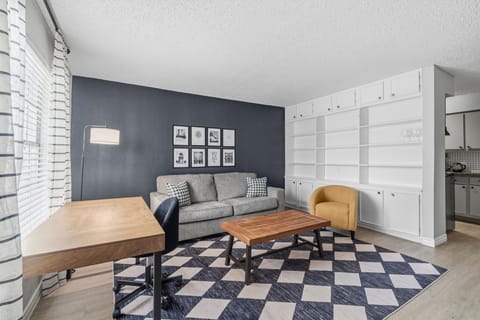 Cozy living area with stylish decor, perfect for relaxation or work, featuring ample natural light and modern furnishings.