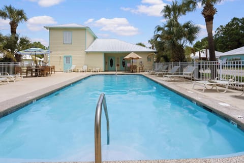 Relax at the shared outdoor pool in the Orange Beach Villas community after a beach day or event at The Wharf.