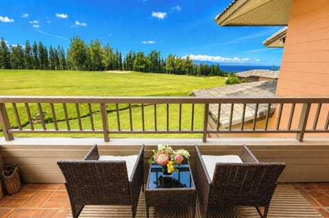 Private lanai framing sweeping fairway and Pacific Ocean views