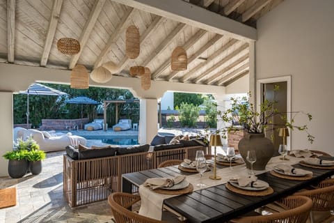 An outdoor dining table set on the covered patio, perfect for alfresco meals.