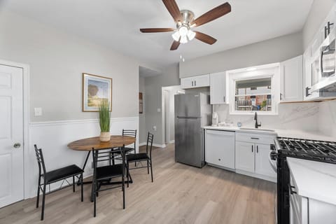 Bright modern kitchen with stainless appliances and cozy dining nook
