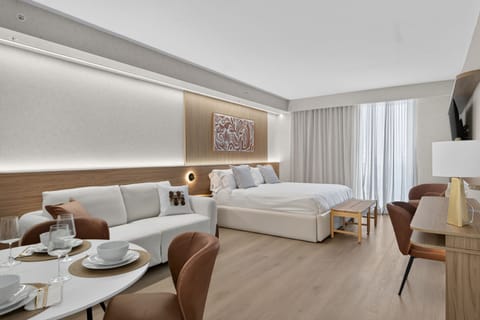 Luxury studio with sofa, king bed and dining table