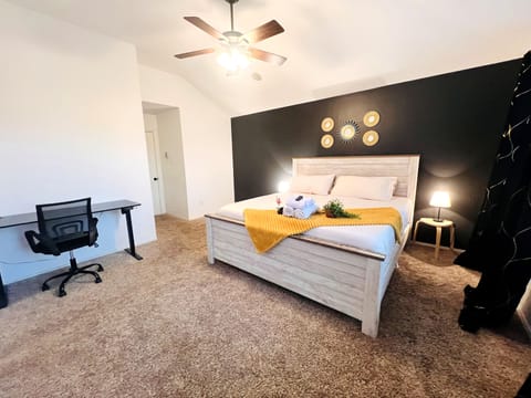 Recharge after demanding workdays in this spacious Aubrey primary bedroom with comfortable king bed, TV and workspace. A restful private retreat for construction crews, contractors, corporate travelers, relocations and extended stays.