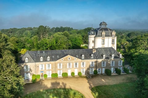 Seen from above, the tower stands out among the surrounding trees and grassy grounds.