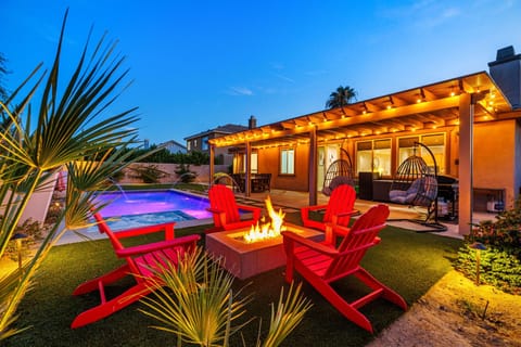 Resort-style pool with a cozy fire pit lounge