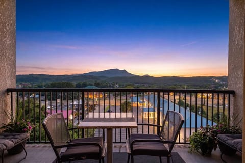 Private balcony with cozy seating and stunning sunset mountain views