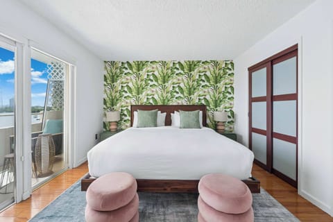 Bright and airy master bedroom featuring a queen size bed, comfortable layout and direct balcony access
