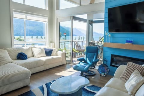 Soaring ceilings and oversized windows fill the penthouse with natural light and lake/mountain views.