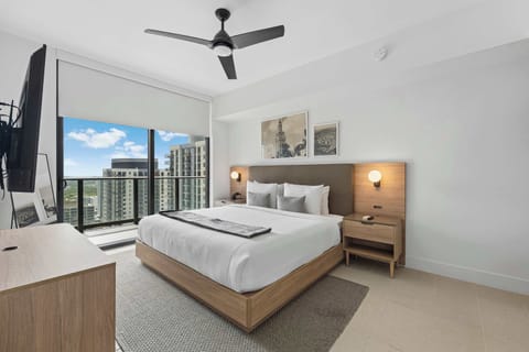 Bright and modern bedroom with a city view balcony access.