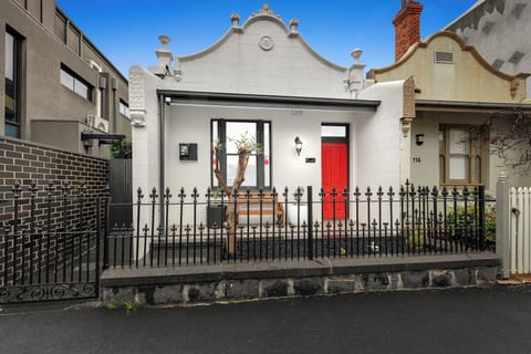 Charming heritage-style home with a bold red door and inviting entry