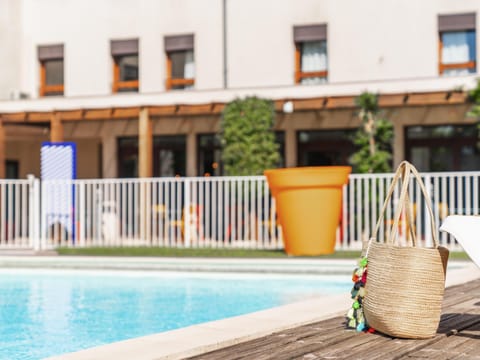 Seasonal outdoor pool, open 9:00 AM to 9:00 PM, pool umbrellas