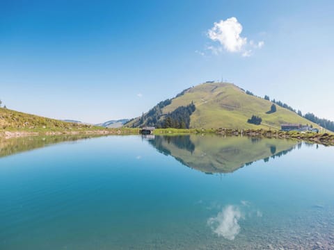 Sky, Blue, Water, Body Of Water, Mountainous Landforms, Natural Landscape, Mountain, Hill, Bank, Highland