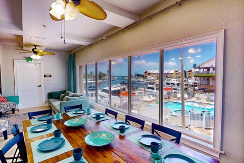 Spacious open-concept living room with spectacular marina and pool views.