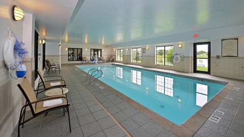 Indoor swimming pool with lounge chairs.