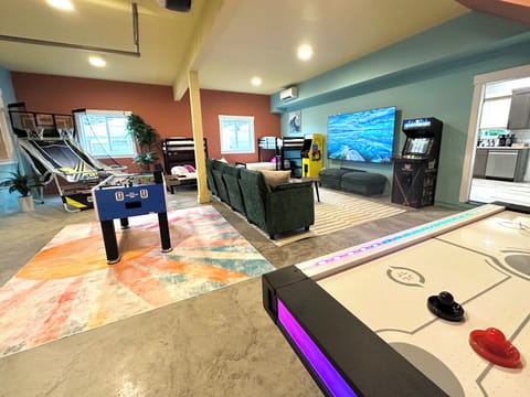 Foosball, air hockey and classic arcade cabinets fill the far end of the lower level — the tournament starts as soon as you drop your bags.
