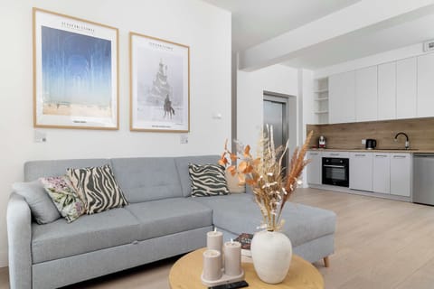 Relax in the stylish living room with a comfortable sofa and modern decor.