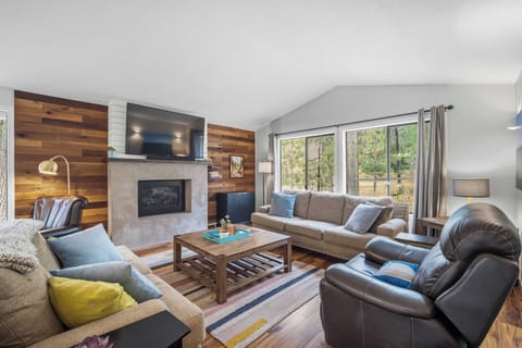 Sink into plush sofas and unwind in your inviting living room, where warm wood accents and a cozy fireplace create the perfect retreat after a day of adventure.