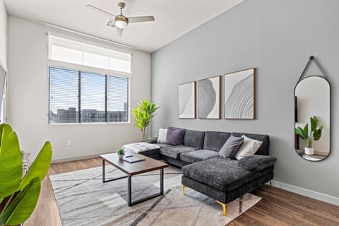 Enjoy this stylish living room featuring elevated ceilings, a smart TV for movie nights, comfortable seating, and board games for evening entertainment.