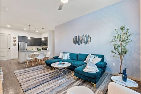 This stylish living room is perfect for entertaining, featuring elevated ceilings, a smart TV, comfortable seating, board games, and a dedicated dining area for the whole group.
