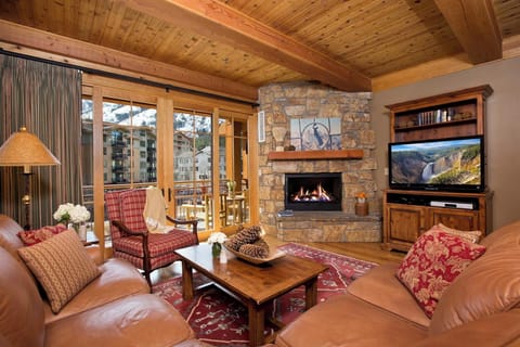 A loveseat and couch face the gas fireplace in the open-plan living room.