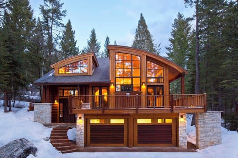 A wrap-around deck and double garage wrap the exterior of the three-floor lodge.