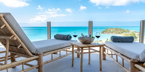 Unwind on sun loungers with endless turquoise ocean views.