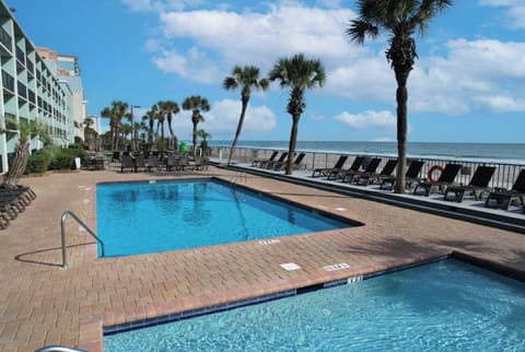 Swim morning laps steps from the beach and loungers.