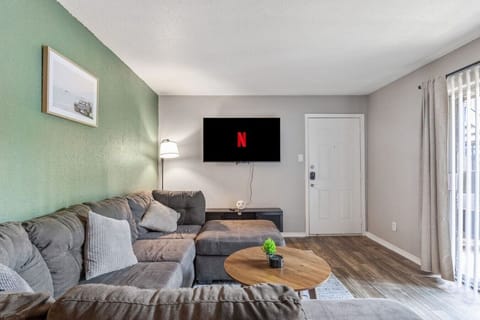 Spacious and inviting living area with comfortable seating and a smart TV, perfect for relaxing after exploring Arlington or attending events at AT&T Stadium.