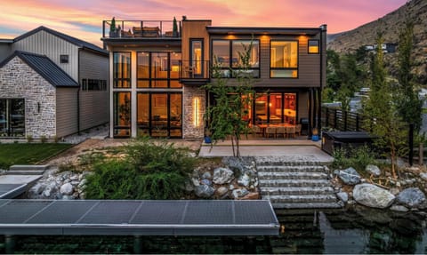 Modern lakeside retreat with rooftop deck, private dock, and sunset views