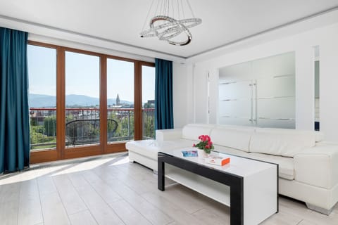 A spacious lounge area with floor to ceiling windows. The perfect place to relax while enjoying the city skyline.