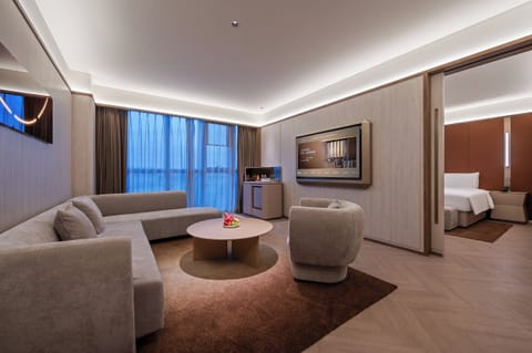 Luxury Suite | Living area | 65-inch LED TV with satellite channels, pay movies
