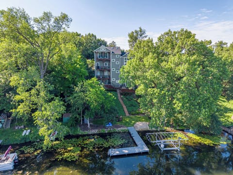 Aerial lakefront view of the multi-level home, private shoreline and dock