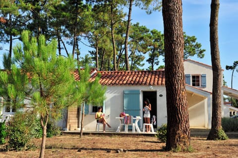 Relax on the terrace beneath the pines, just steps from the path down to Conches beach.