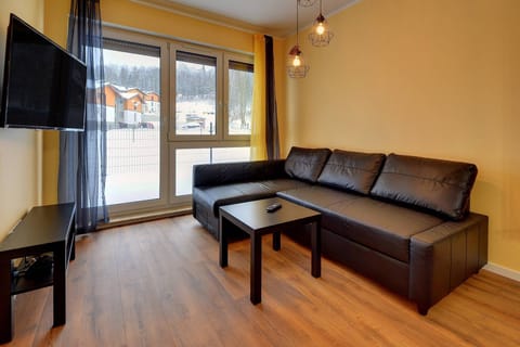 Relax in the stylish living room with a comfortable sofa and cosy decor.