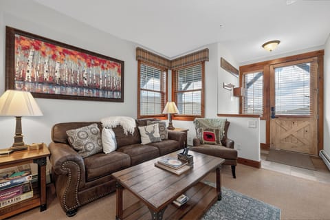 Settle into your cozy living room, where plush seating and warm wood accents invite you to unwind after a day of adventure.