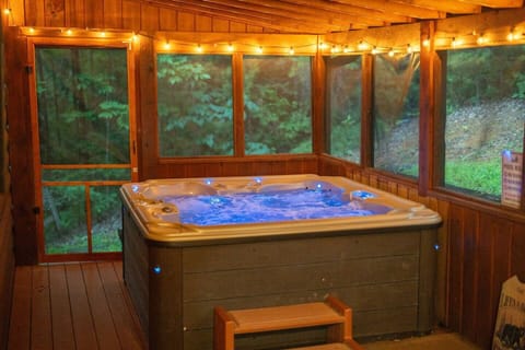 Screened hot tub with forest views, glowing under string lights 🌲✨