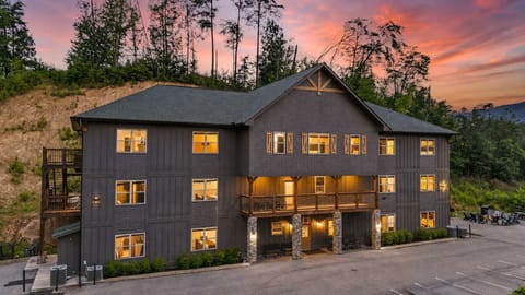 This spacious Pigeon Forge group lodge features an indoor pool, two hot tubs, an arcade, and accommodations for up to 76 guests.