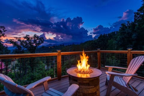 Cozy fire pit deck with stunning mountain sunset views