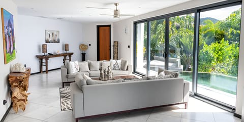 Stretch out on designer sofas with uninterrupted oceanfront vistas.