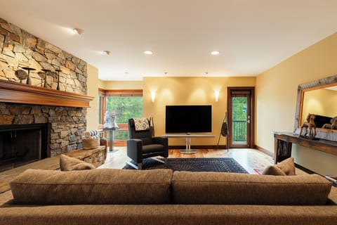 Living room with gas-assisted stone fireplace