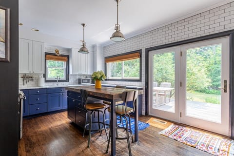 Bright kitchen with an oversized island and direct access to the back deck