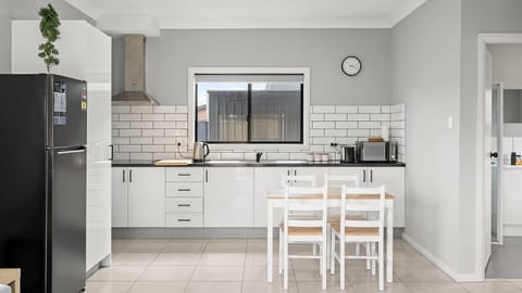 Bright open-plan kitchen and dining with everything you need for a comfortable stay.