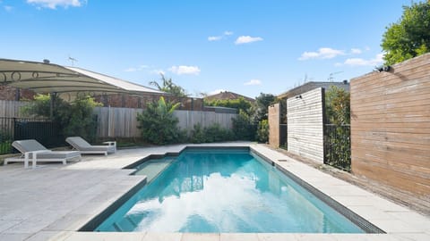 Cool off in the inviting pool while enjoying the privacy of the fully fenced backyard.