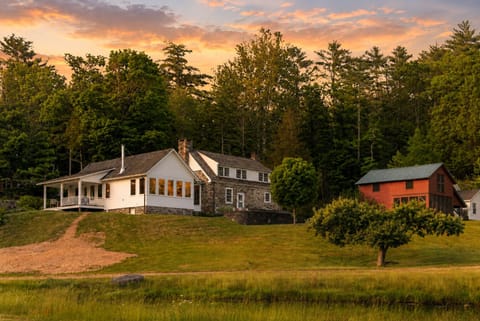 Exterior view of the home nestled among towering trees, offering a peaceful and scenic retreat.
