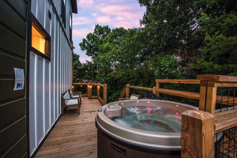 Unwind in your private hot tub on the deck, surrounded by lush greenery and soft twilight. The perfect retreat after a day of adventure.