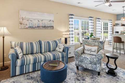 microwave, interior, indoor, climate control, couch, refrigerator, living area, desk, daytime, kitchen island with seating