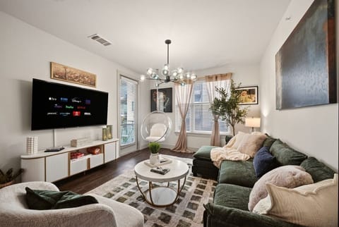 Living Room: Bright and stylish space with a modern vibe and large screen for ultimate entertainment!