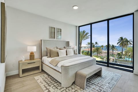 Primary king bedroom with ocean and palm view