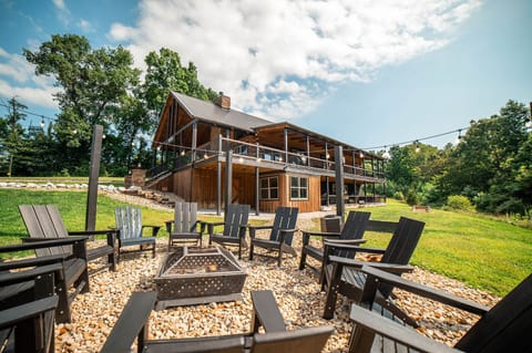 Serenity Ridge, a luxury log estate. Comfortably sleeps 20 with an in-ground heated swimming pool, hot tub, Pool table, full bar, Poker room, you name it!