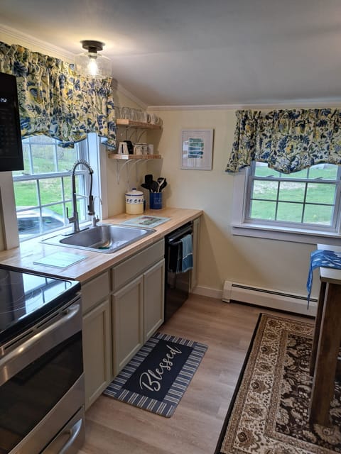 The kitchen is compact but well-equipped for simple meals and relaxed mornings.